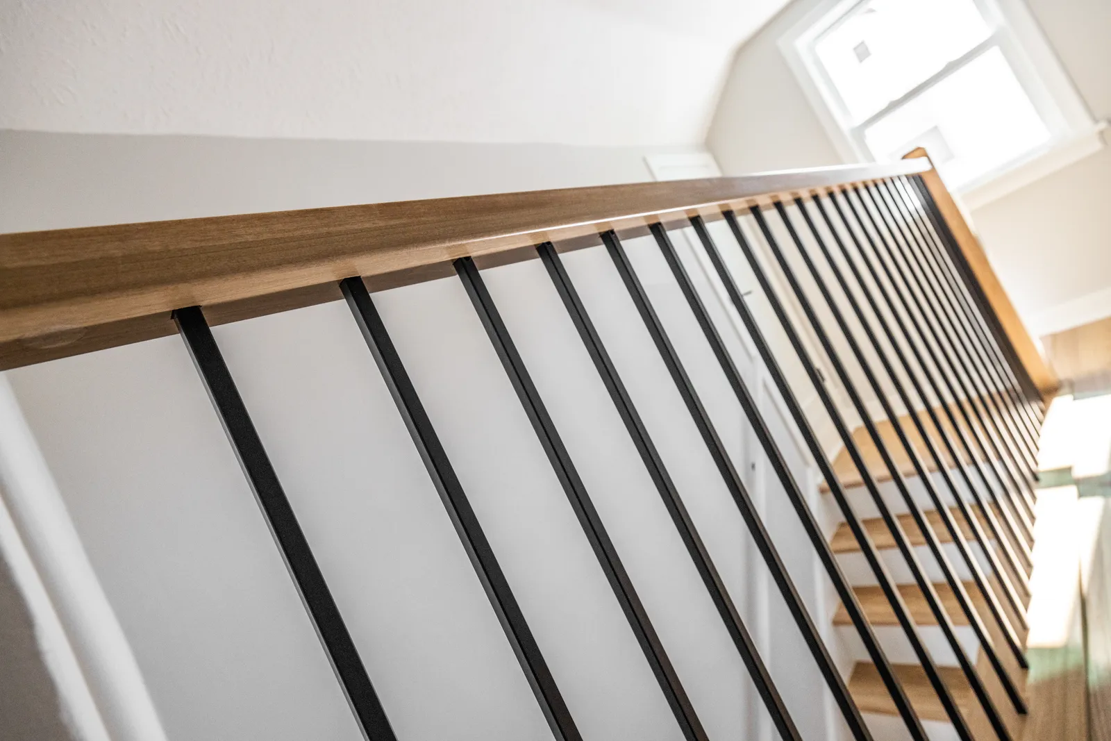 Walnut railing cap and iron spindle detail